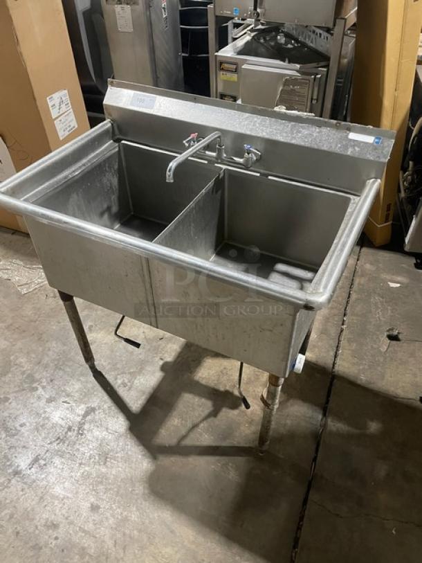 All stainless steel 2-compartment dishwashing/prep sink with faucet and legs, industrial design, good condition.