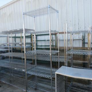 Metro metal shelving unit with five wire shelves, dimensions 30x18x87 inches. Multiple units visible in industrial setting.