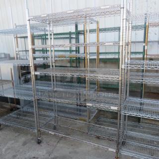 Metro shelf unit with five wire shelves and casters, 48x18x76 inches. Sturdy metal construction, used condition.