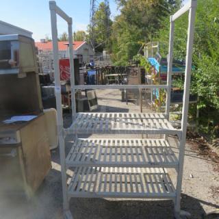 Cambro shelving system with 3 ventilated shelves on casters, 42x24x75 inches. Used condition, outdoor setting.