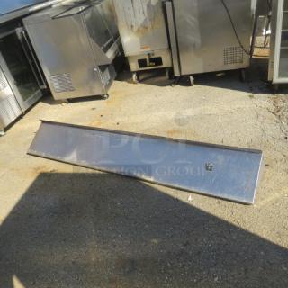 Stainless steel wall mount shelf with brackets, 72x12x10 inches, used condition, visible surface wear.