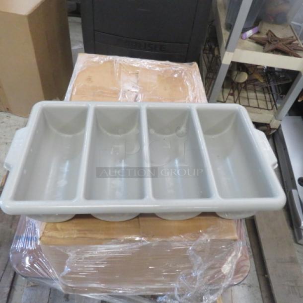 Gray plastic flatware holder with four compartments, handles on sides. Used condition, suitable for organizing cutlery.
