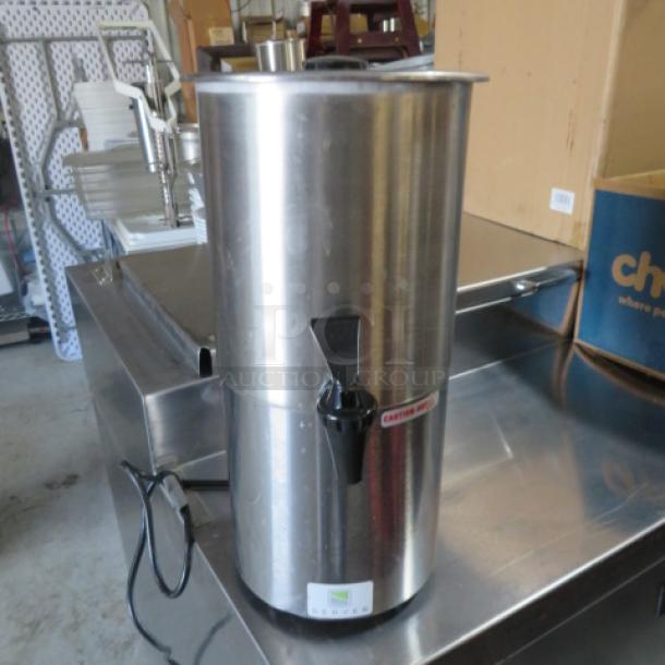 Stainless steel Server warmer/dispenser, vertical design, black spigot, power cord attached, catering label visible.