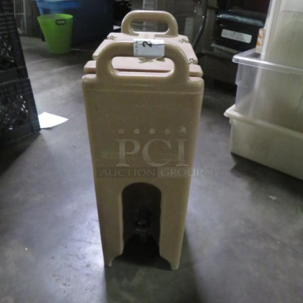 Cambro Portable Drink Dispenser, model 500LCD, beige, with top handle. Good condition, auction label visible.