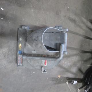 Metallic One Pelican Head Attachment in used condition, features mounting base, clamps, and visible caution labels indicating safety guidelines.