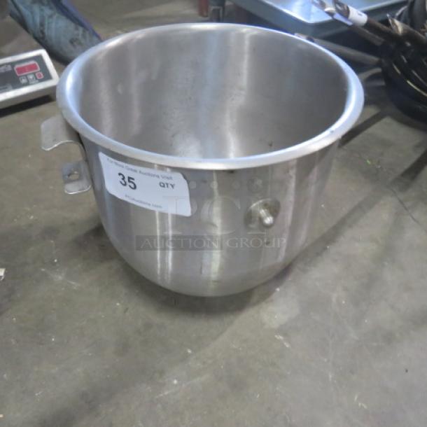 Stainless steel 20-quart mixer bowl, used condition, with handle and attached label marked "35 QTY".