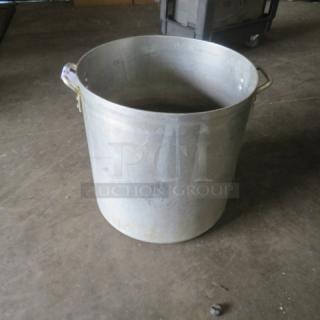 Aluminum stock pot, 18x9.5 inches, with side handles. Visible signs of wear, ideal for large batch cooking.