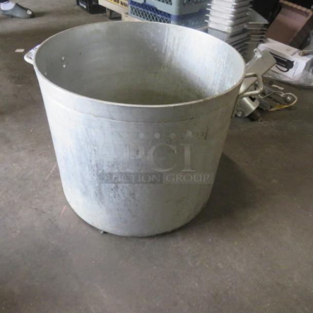 Large aluminum stock pot, 21x18 inches, used condition with visible wear. Ideal for bulk cooking or industrial use.