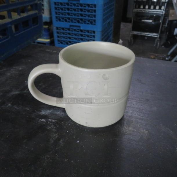 Beige stoneware coffee mug, cylindrical shape, sturdy handle, lightly worn surface, plain design, no visible markings.