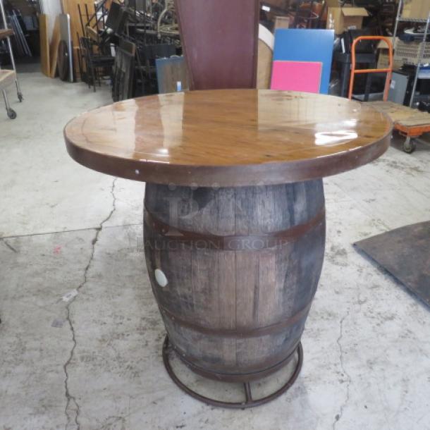 Whiskey barrel bar height table, 41x42 inches, wood top, rustic finish, sturdy barrel base, excellent condition.