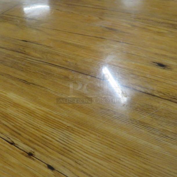 Whiskey barrel bar height table, 41x42 inches, polished wood surface, unique grain pattern. Ideal for rustic decor.