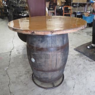 Whiskey barrel bar height table, 41x42 inches, distressed wood finish, missing metal ring around tabletop.