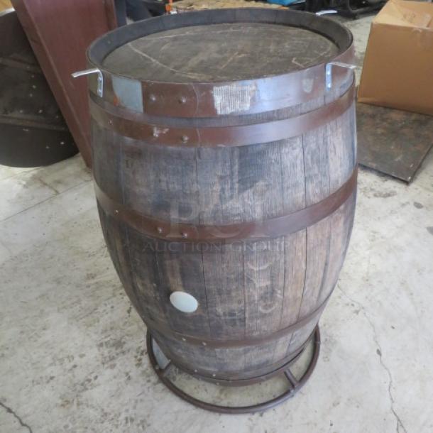 Whiskey barrel bar height table, 41x42 inches. Missing metal ring around table top, rustic wood finish, metal accents.