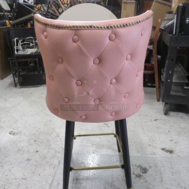 Vintage-look pink cushioned bar stool, counter height with swivel seat, tufted back, nailhead trim, gold footrest.