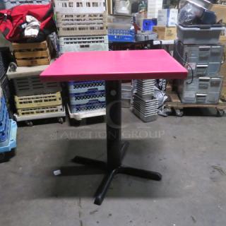 Pink solid wooden table, bar height pedestal base, 24x30x35.5 inches, excellent condition.