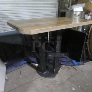 Wooden table with a wooden base, measuring 54x36x43 inches. Features a natural finish and sturdy design. Good condition.