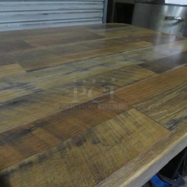 Wooden table with a natural finish, measuring 54x36x43 inches, on a sturdy wooden base. Excellent condition.