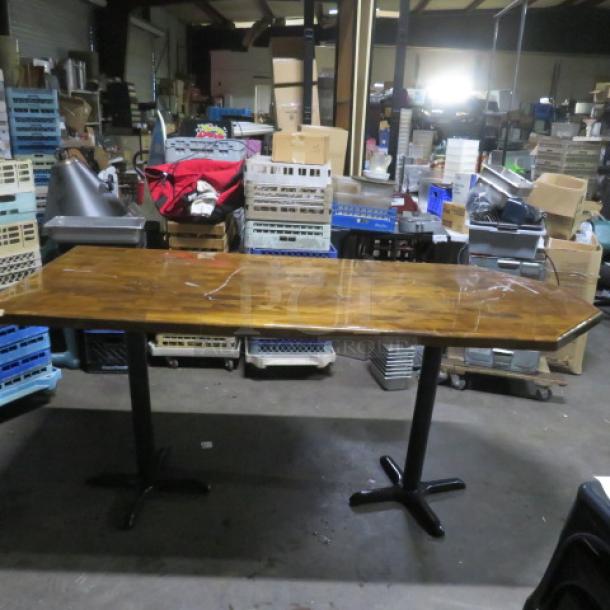 Wooden table top on dual bar height base, dimensions 72x36x43 inches. Good condition with visible wood grain.