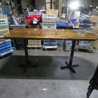Wooden tabletop with dual bar height black metal base, 72x36x43 inches, in used condition, suitable for dining or bar setup.