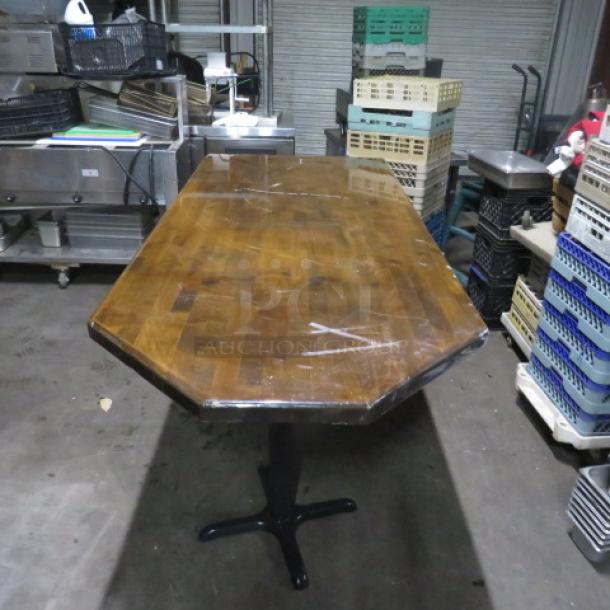 Wooden tabletop with dual bar height base, dimensions 72x36x43 inches. Good condition, sturdy design, octagonal edges.