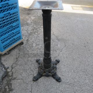 Cast iron ornate base with intricate detailing, vintage design. Sturdy condition, ideal for supporting tables or stands.