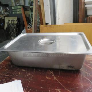 Full-size stainless steel hotel pan with lid, 6 inches deep, used condition. Ideal for catering and food service.