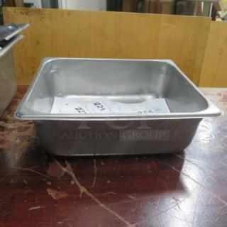One 1/2 size, 4-inch deep hotel pan, metal, used condition, visible auction number inside, suitable for catering use.