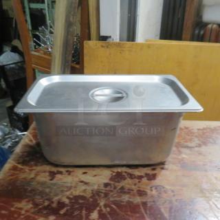 One 1/3 Size 6 Inch Deep Hotel Pan with Lid, stainless steel, used condition, suitable for commercial kitchen use.
