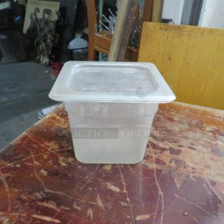 Clear 1/6 size, 6-inch deep food storage container with lid, light wear. Ideal for kitchen or catering use.