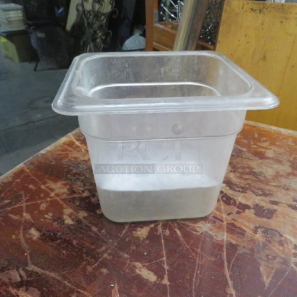 1/6 size, 6-inch deep food storage container, clear plastic, used condition, visible wear, ideal for kitchen organization.