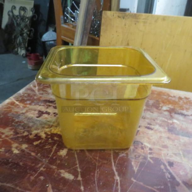 Amber 1/6 size, 6-inch deep food storage container. Used, clear markings on side, ideal for restaurant or catering.