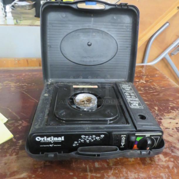 Portable gas range in black carrying case. Features single burner, controls, and "Original" branding. Used condition.