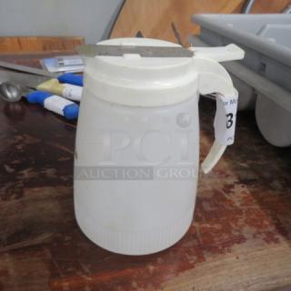 White plastic syrup dispenser with a metal lid and handle. Used condition with a label marked "3".