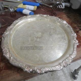 12" silver plate platter with ornate rim, engraved design, minor tarnish. Suitable for decorative or serving use.