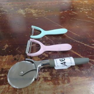 Assorted kitchen utensils including a pizza cutter and two peelers, one pink and one blue. Item tag reads "346."