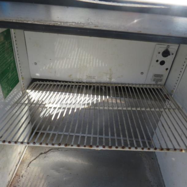 True 1 Door Worktop Freezer, Model TWT-27F, on casters. Measures 27.5"x30"x40". Visible wire shelf, used condition.