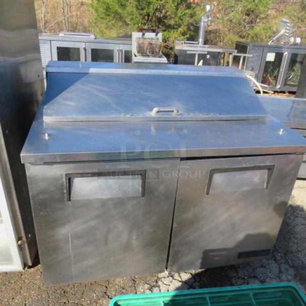 True TSSU-48-12 refrigerated prep table, 2 doors, 1 rack, on casters, stainless steel, 48x30x42.5 inches, 115V.