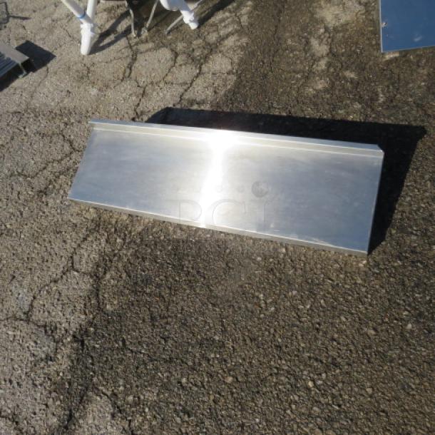 Stainless steel wall mount shelf with brackets, 36x10.5x6 inches, reflective surface, new condition.