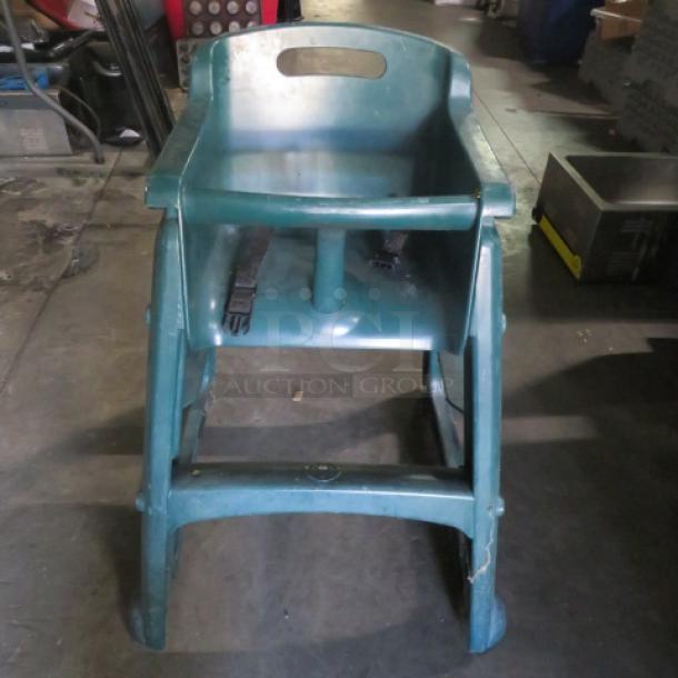 Poly high chair with safety straps on casters, durable plastic, blue hue. Shows wear. Ideal for childcare use.