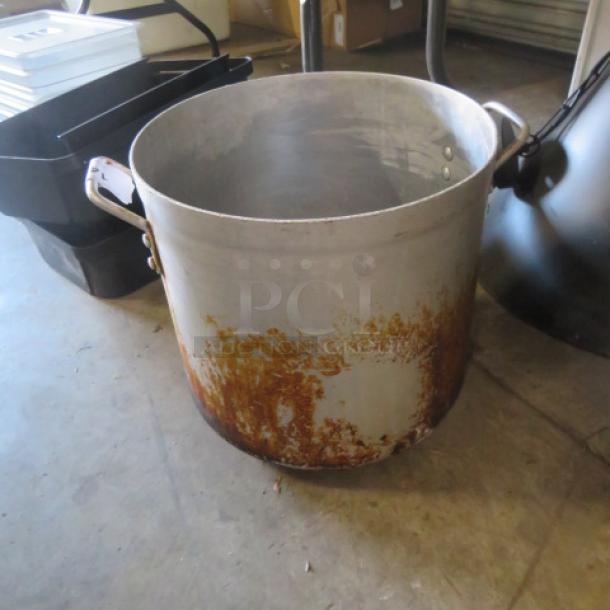 Large aluminum stock pot with side handles, showing rust and wear. Suitable for heavy-duty cooking or industrial use.