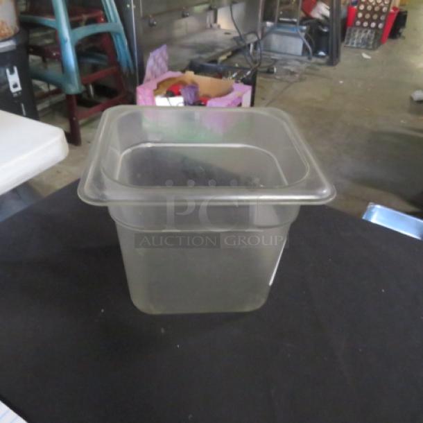 Clear 1/6 size, 6-inch deep food storage container; durable plastic, used condition, ideal for kitchen organization.