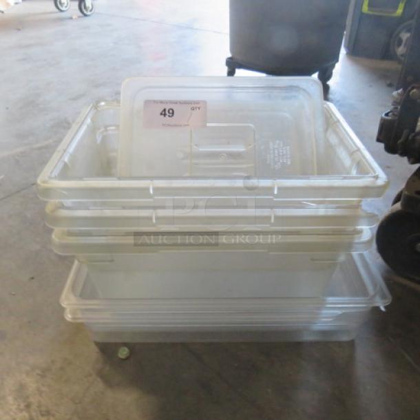 Stack of clear plastic storage bins, varying sizes, in used condition. Label shows lot number 49 for auction identification.