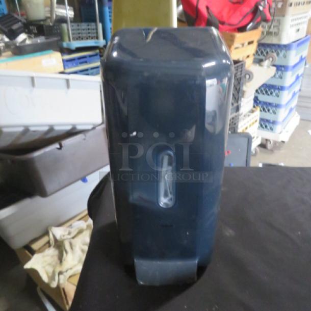 New wall mount soap dispenser, dark blue, rectangular design, transparent window, in excellent condition.