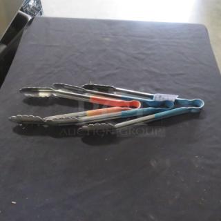 Assorted stainless steel tongs with colored grips, laying on a table, used condition, visible tag: "3XBID".