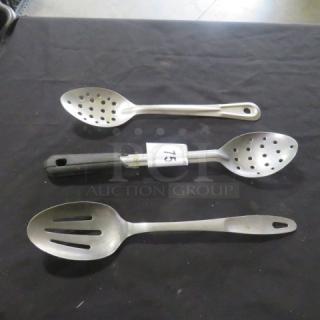 Assorted stainless steel slotted spoons, set of three, with varied handle designs; tag labeled "75" visible on one spoon.