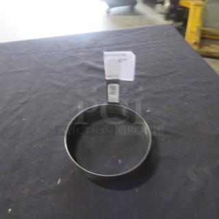 Stainless steel egg ring, circular shape, good condition, label attached, possibly mentions item details.