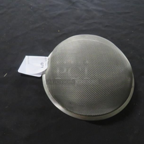 Metal sifter with fine mesh, slightly domed, appears unused. Tag attached indicates item name as "One Sifter."