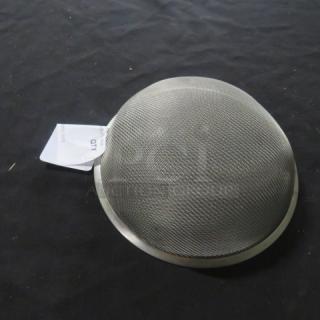 Metal sifter with fine mesh, slightly domed, appears unused. Tag attached indicates item name as "One Sifter."