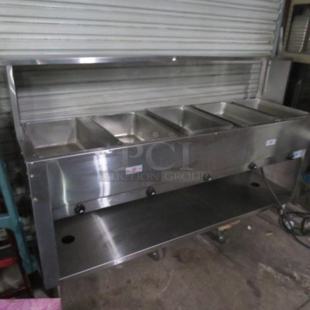 Advance Tabco 5-well steam table, model HF-5E-240-BS, with under shelf, stainless steel over shelf, plexiglass sneeze guard, on casters.