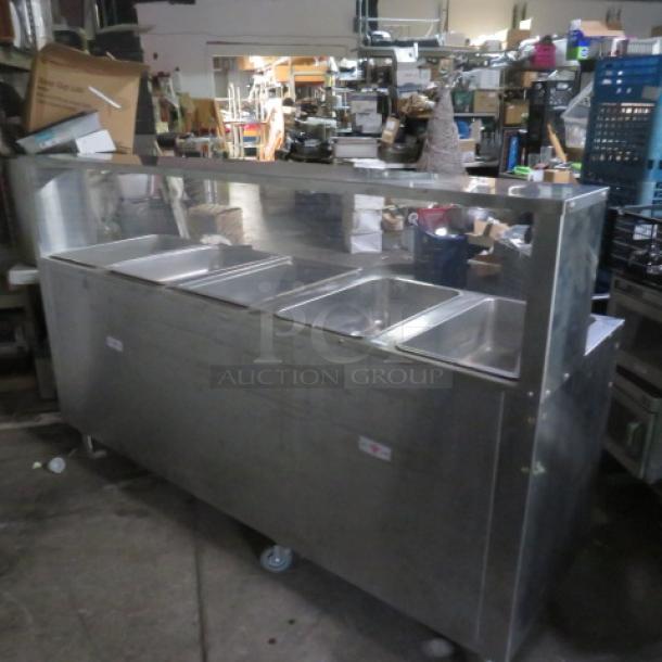 Advance Tabco SS 5 Well Steam Table, Model HF-5E-240-BS, with under and over shelves, plexiglass sneeze guard, on casters.
